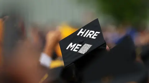 Getty Images Graduate with sign on hat