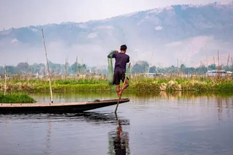 BBC A fisherman on a boat in Myanmar