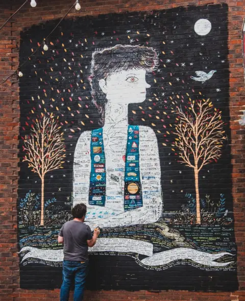 Neil McCarty David Litchfield painting his mural