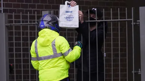 Getty Images Student receiving a takeaway in their halls of residence