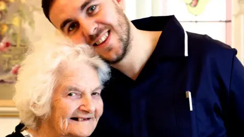Fairhaven Lodge Carer Neal Williams with resident Kitty O'Dea