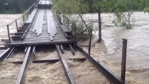 YouTube/Altai Mountains News The Altai bridge damaged by floods