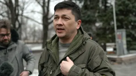AFP Image shows Vitaly Kim standing speaking to a camera