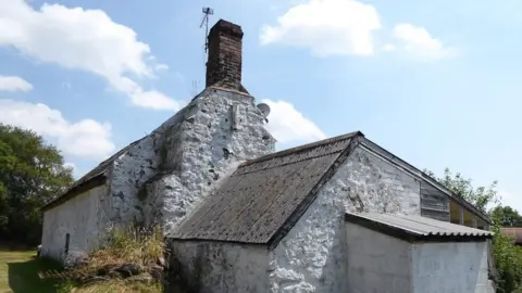 Historic England The "Squatter's cottage" in Cleeton St Mary