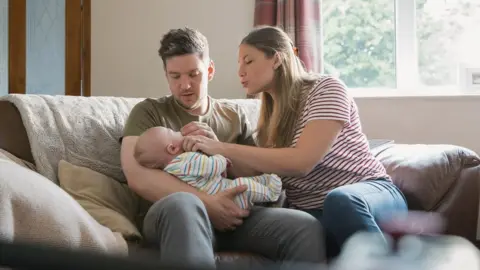 Getty Images Parents with baby