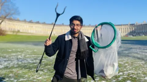 University of Bristol Vivek Gurav holding a litter grabber and bin bag