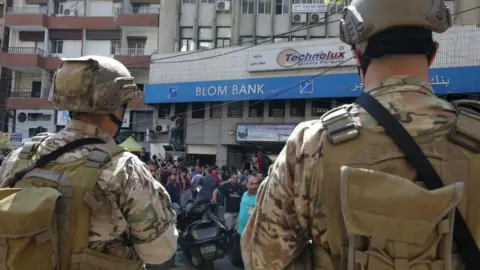 BBC News Security forces outside a bank