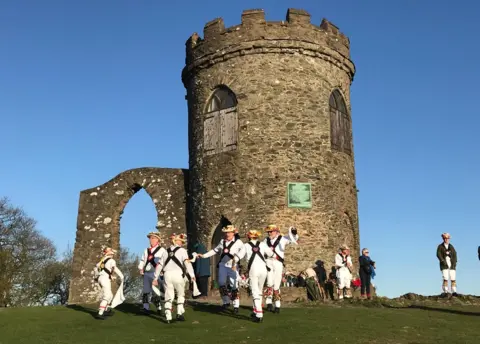 Sky girl Leicester Morris Men at the Old John Tower in Bradgate Park, Leicestershire