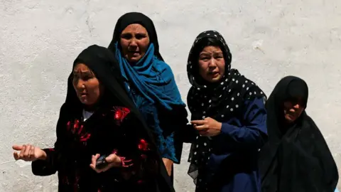 Reuters Relatives of the victims mourn at a hospital after a suicide attack in Kabul, Afghanistan, 22 April