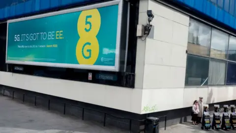 In Pictures / Getty Images An EE billboard for 5G in London