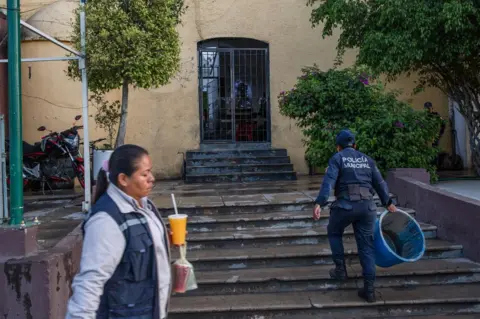 Brett Gundlock A municipal police officer walks into the local police station in Acatlán, Puebla