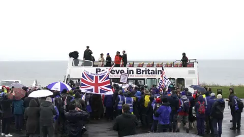 Getty Images Nigel Farage makes a speech to marchers from the top of an open top bus