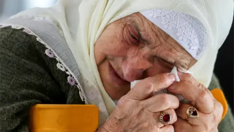 Reuters A Bosnian Muslim woman reacts as she awaits the final verdict of former Bosnian Serb military leader Ratko Mladic