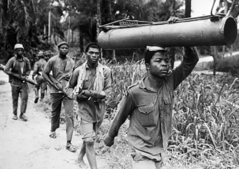 Getty Images Men carrying a weapon