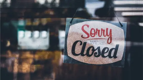 Getty Images A sign reading "sorry we're closed"