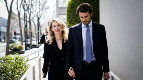 Getty Images Former Theranos CEO Elizabeth Holmes leaves a hearing in San Jose, California with her partner Billy Evans