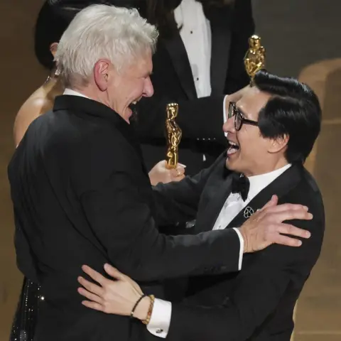 Reuters Ke Huy Quan receives the Oscar for Best supporting actor from Harrison Ford after "Everything Everywhere All at Once" won during the Oscars show at the 95th Academy Awards in Hollywood, Los Angeles, California, U.S., March 12, 2023