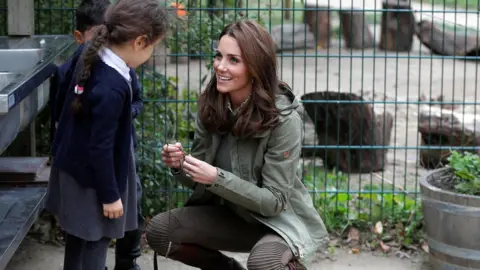 PA Duchess of Cambridge crouching down