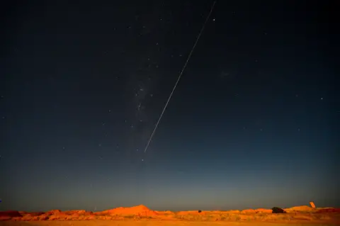 Morgan Sette / AFP A capsule from Japan's Hayabusa-2 space probe streaks through the night sky