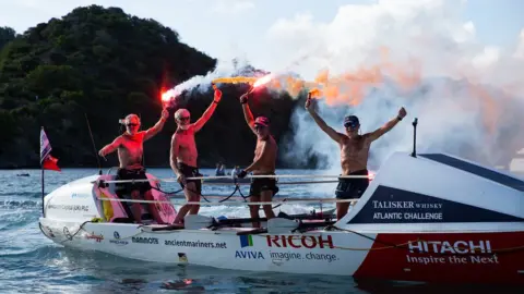 Hitachi UK The Ancient Mariners celebrate at the finish line in Antigua