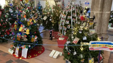 Luke Deal/BBC Christmas trees on display at Sudbury Arts Centre