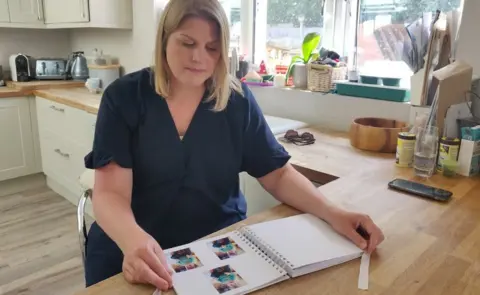 Julia Rogers looking at photos of her son Louis