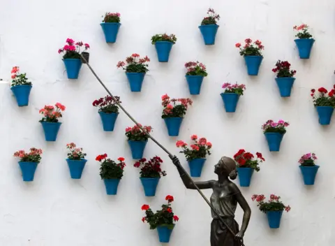 Cristina Quicler / AFP The sculpture The Waterer