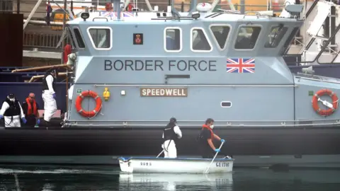 PA Media Border Force team with a small rowing boat