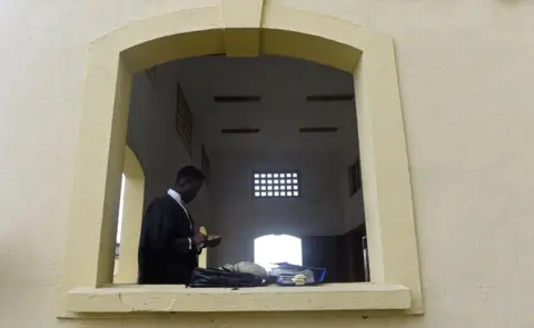Getty Images A male lawyer checking his phone at the balcony of a courtroom at the Lagos State High Court in Lagos, Nigeria - Tuesday 29 January 2019