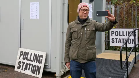 Getty Images A person takes a selfie at a polling station in London in 2019