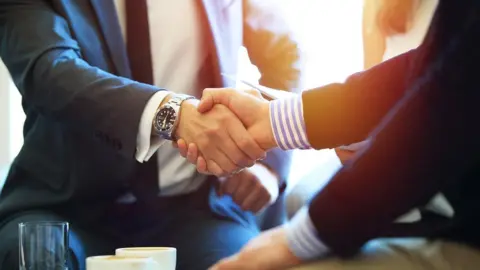 Getty Images business colleagues handshaking