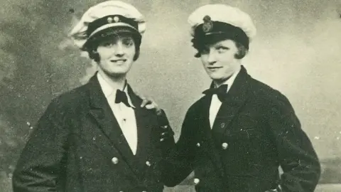 Getty Images Two women dressed as Navy officers