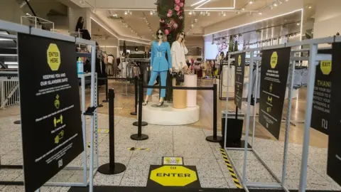 PA Media Signage reminding shoppers of social distancing rules in a River Island store in Liverpool, as shops make preparations to reopen following the introduction of measures to bring England out of lockdown.