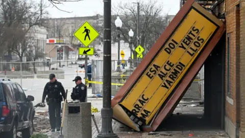 EPA nvestigators look over the Apollo Theater following a tornado in Belvidere, Illinois