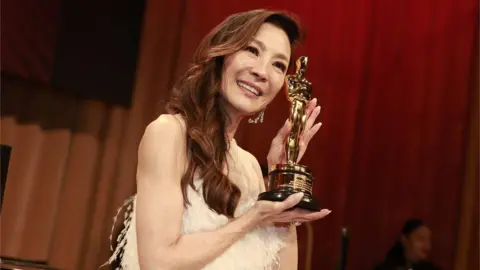 Getty Images Michelle Yeoh accepts the Oscar for Best Actress during the Oscars show at the 95th Academy Awards in Hollywood, Los Angeles, California