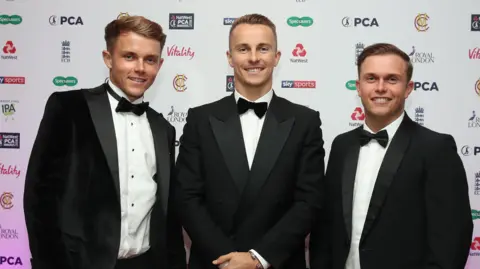 Sam, Tom and Ben Curran wearing tuxedos at the PCA awards