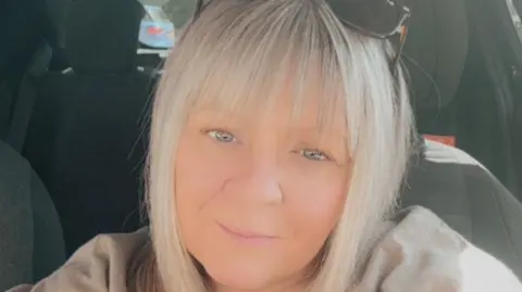 A woman with long blonde hair