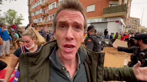 The BBC's Mark Lowen stands amidst scenes of chaos and flooding damage in Paiporta, the worst hit suburb of Valencia