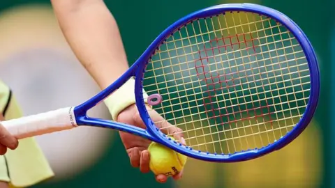 A close up picture of a tennis racquet