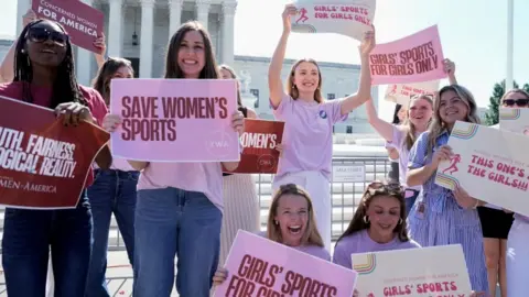 Reuters Women hold placards as they celebrate the US Supreme Court's ruling