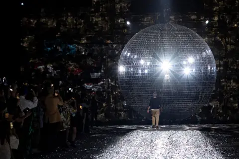  Andre Pain, EPA Designer Dries Van Noten walks towards giant disco ball paris fashion week