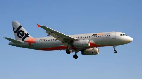 A Jetstar Asia Airways Airbus 320 lands at Phuket airport. 