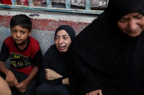 Reuters A woman mourns at the scene of an Israeli attack on a UN school in the Nuseirat refugee camp