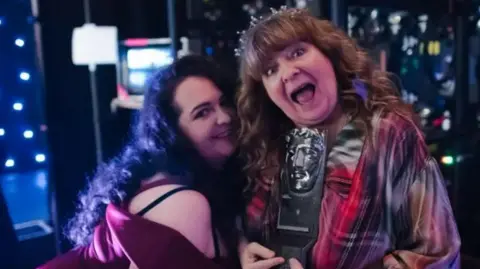 Getty Images Janey Godley, right, holding an award, with her daughter, Ashley Storrie, left.