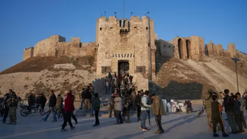 EPA A number of people, some with firearms, outside the citadel