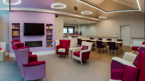 Kirklees Council A colourful room full of chairs, tables and a TV set