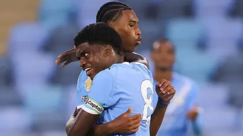 Reigan and Jaden Heskey hug