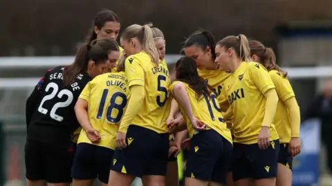 Oxford United players in a huddle during the FA Cup Third Round match between Oxford and Bristol Rovers in December 2024. 