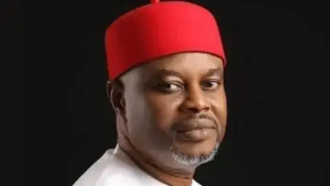 Bayo Onanuga/X A close-up of Uche Nnaji wearing a red hat 