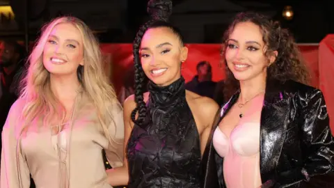 Getty Images Perrie Edwards, Leigh-Ann Pinnock and Jade Thirlwall pictured together in 2021.